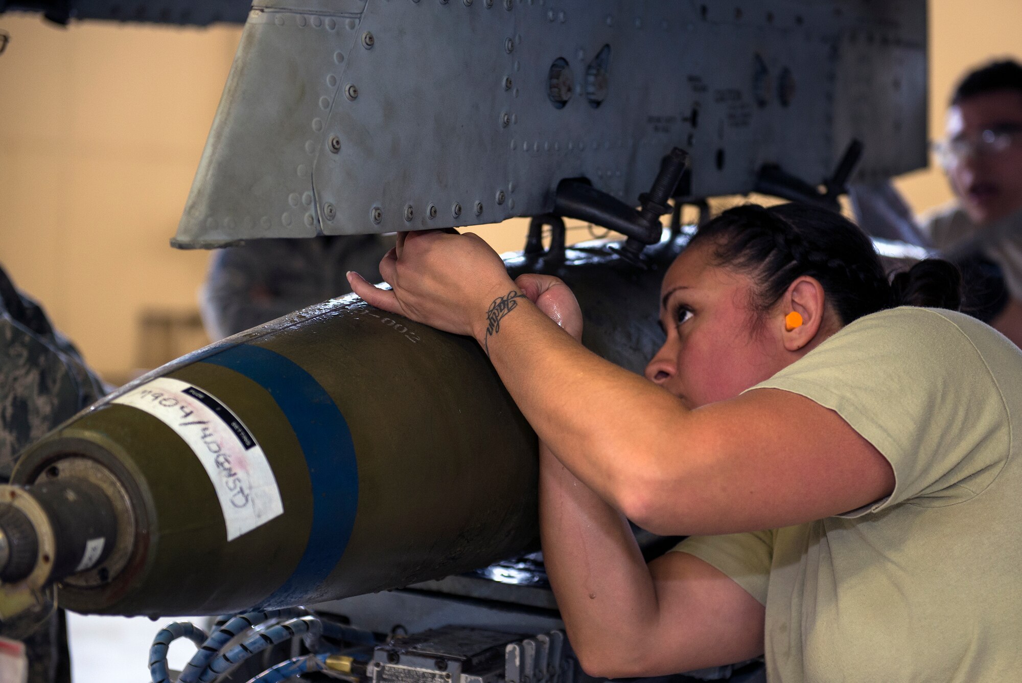 U.S. Air Force Staff Sgt. Raynette Hardcastle, 74th Aircraft Maintenance Unit weapons load team chief, aligns an MK-82 high drag bomb onto an A-10C Thunderbolt II during the quarterly weapons load competition, Jan. 15, 2016, at Moody Air Force Base, Ga.  Hardcastle’s primary job was to review checklist procedures, monitor her team members and ensure the overall load went smoothly. (U.S. Air Force photo by Airman 1st Class Greg Nash/Released) 