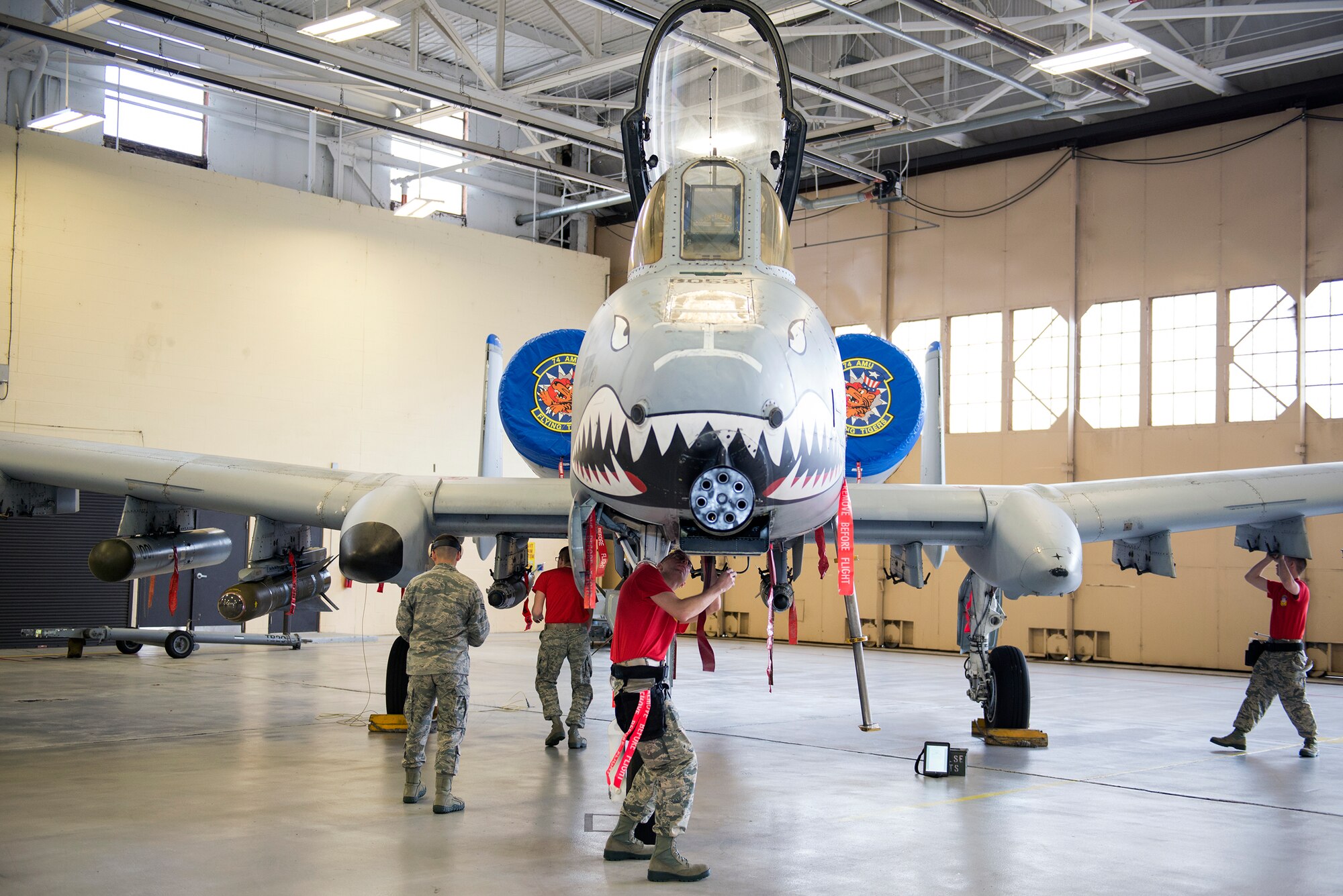 Members of the 75th Aircraft Maintenance Unit participate in the quarterly weapons load competition, Jan. 15, 2016, at Moody Air Force Base, Ga. Two three-man load crews from the 74th and 75th AMU  compete every quarter on the aspects of  proficiently loading bombs, taking a 25-question knowledge test, a tool box inspection, and a dress and appearance evaluation. (U.S. Air Force photo by Airman 1st Class Greg Nash/Released) 