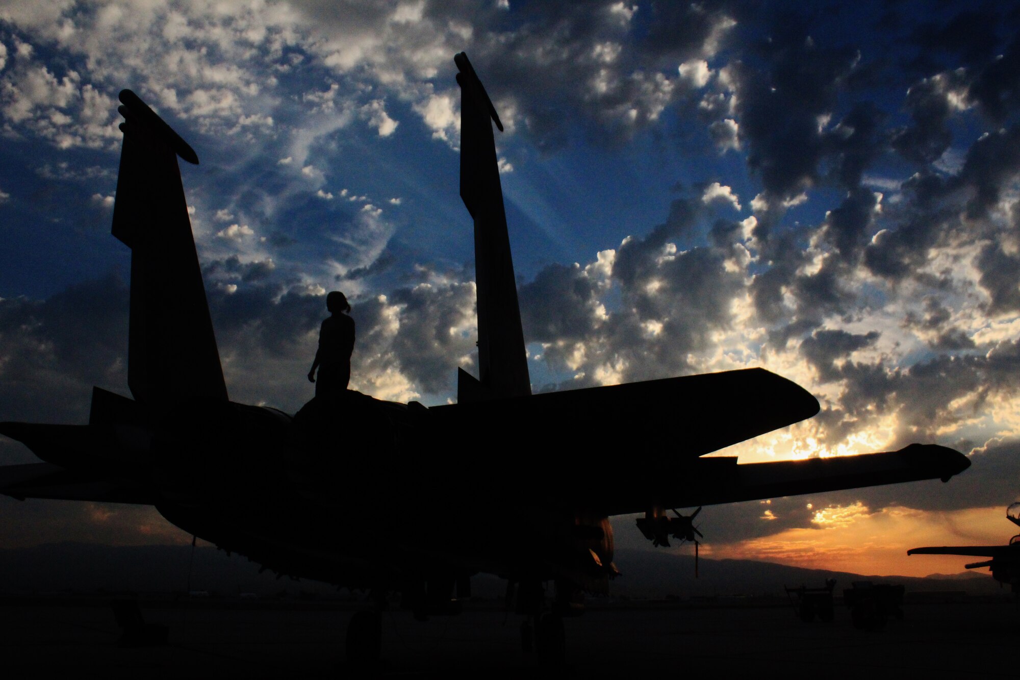 Airman 1st Class Kristin Hall, a 389th Aircraft Maintenance Unit crew chief, stands on an F-15E Strike Eagle at Gowen Field, Idaho, on Aug. 25, 2015. The 366th Maintenance Group spent 90 days at Gowen Field while the Mountain Home Air Force Base runway was under repair. (Courtesy photo by Lt. Col. John Jacobus)