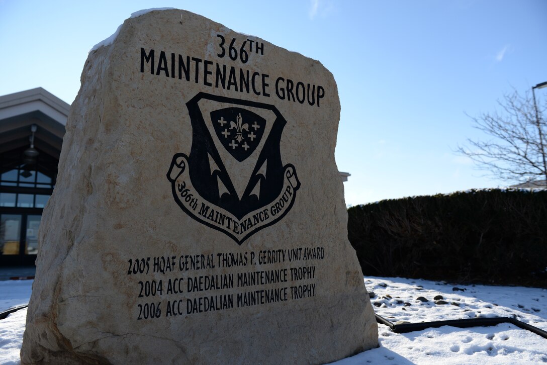 Several awards adorn an engraved stone sign outside 366th Maintenance Group Headquarters on Mountain Home Air Force Base, Idaho, on Dec. 29, 2015. A new line might be added to reflect the Clements McMullen Memorial Daedalian Weapons Systems Maintenance Trophy if the Regulators’ package wins at the Air Force level. (U.S. Air Force Photo by Senior Airman Shane Mitchell/RELEASED)