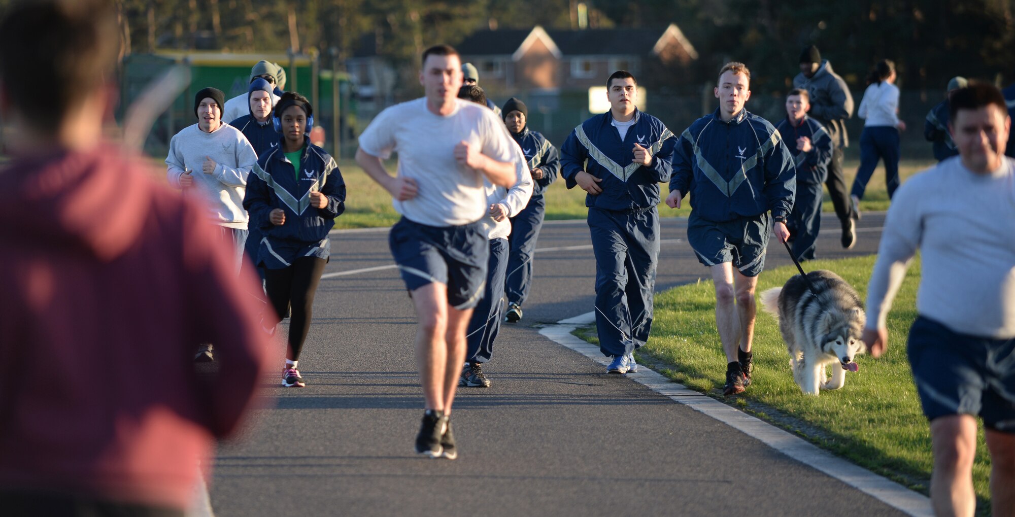 U.S. Air Force members from the 100th Air Refueling Wing run the monthly 5k around the flightline Jan. 15, 2016, on RAF Mildenhall, England. The 5k is mandatory for all Airmen on base to run and is open to all with base access. (U.S. Air Force photo by Senior Airman Christine Halan/Released)