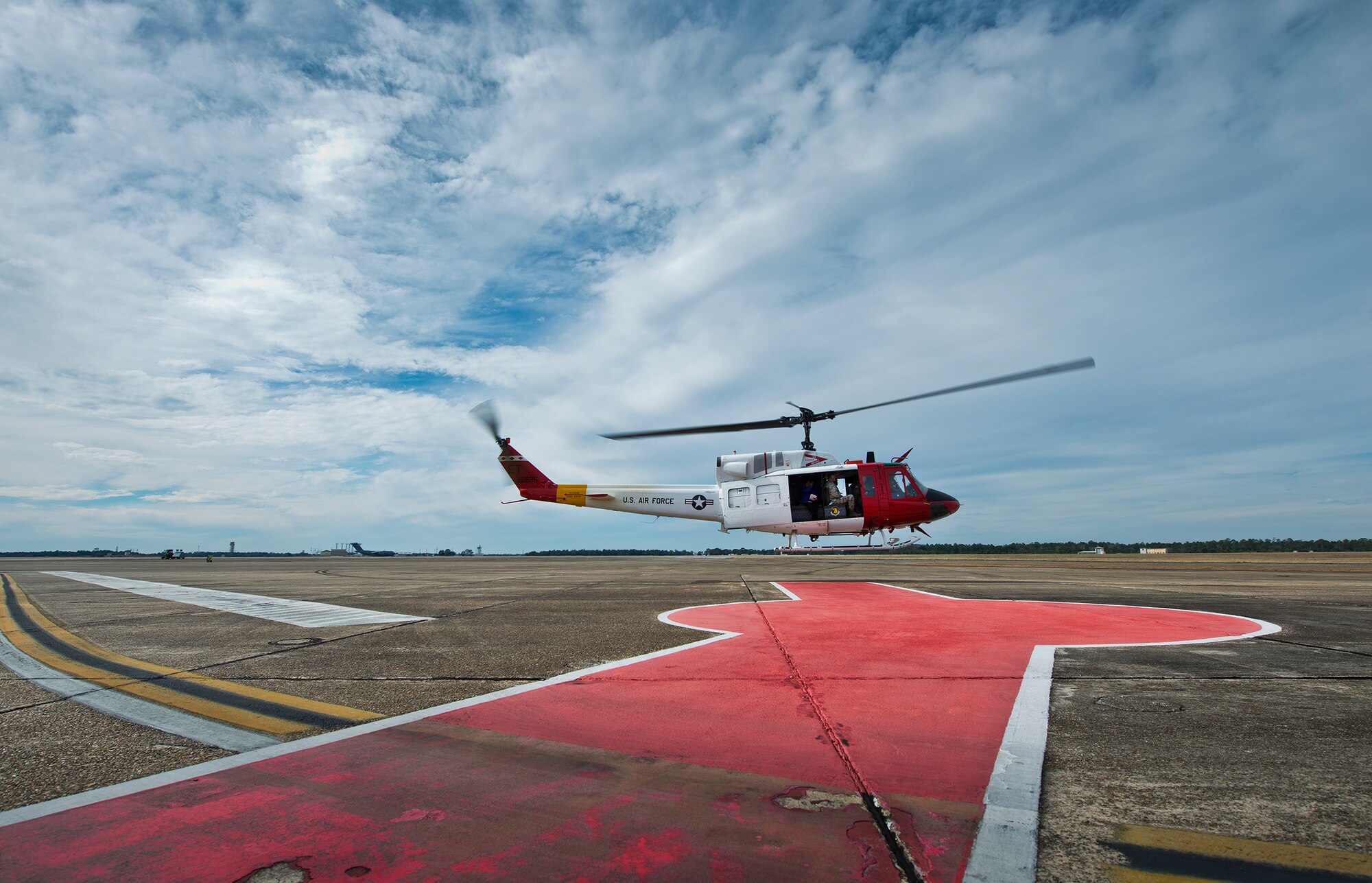 A UH-1 Huey lifts off from the flightline Jan. 14 at Eglin Air Force Base, Fla.  The Huey flight was a touring sortie carrying the Commander-In-Chief’s Installation Excellence Award evaluation team to see Eglin’s range and tenant units.  (U.S. Air Force photo/Samuel King Jr.)