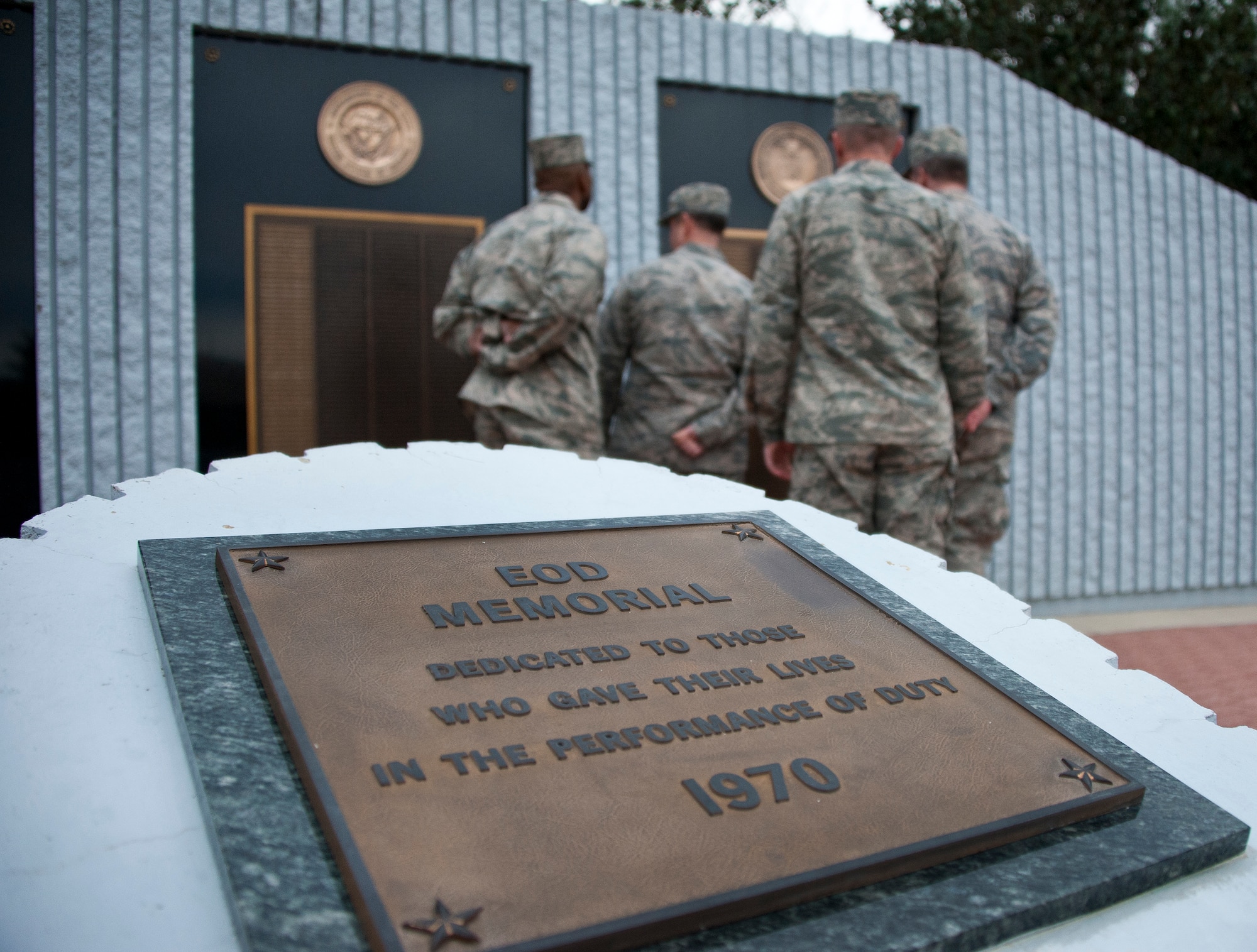The Commander-In-Chief’s Installation Excellence Award evaluation team looks at the names of Air Force explosive ordnance disposal technicians on the memorial wall at the Navy’s EOD school Jan. 14 at Eglin Air Force Base, Fla.  The evaluators were introduced to the base and visited its various tenant units spread throughout Eglin’s vast range space on the first of their two-day visit.  (U.S. Air Force photo/Ilka Cole)
