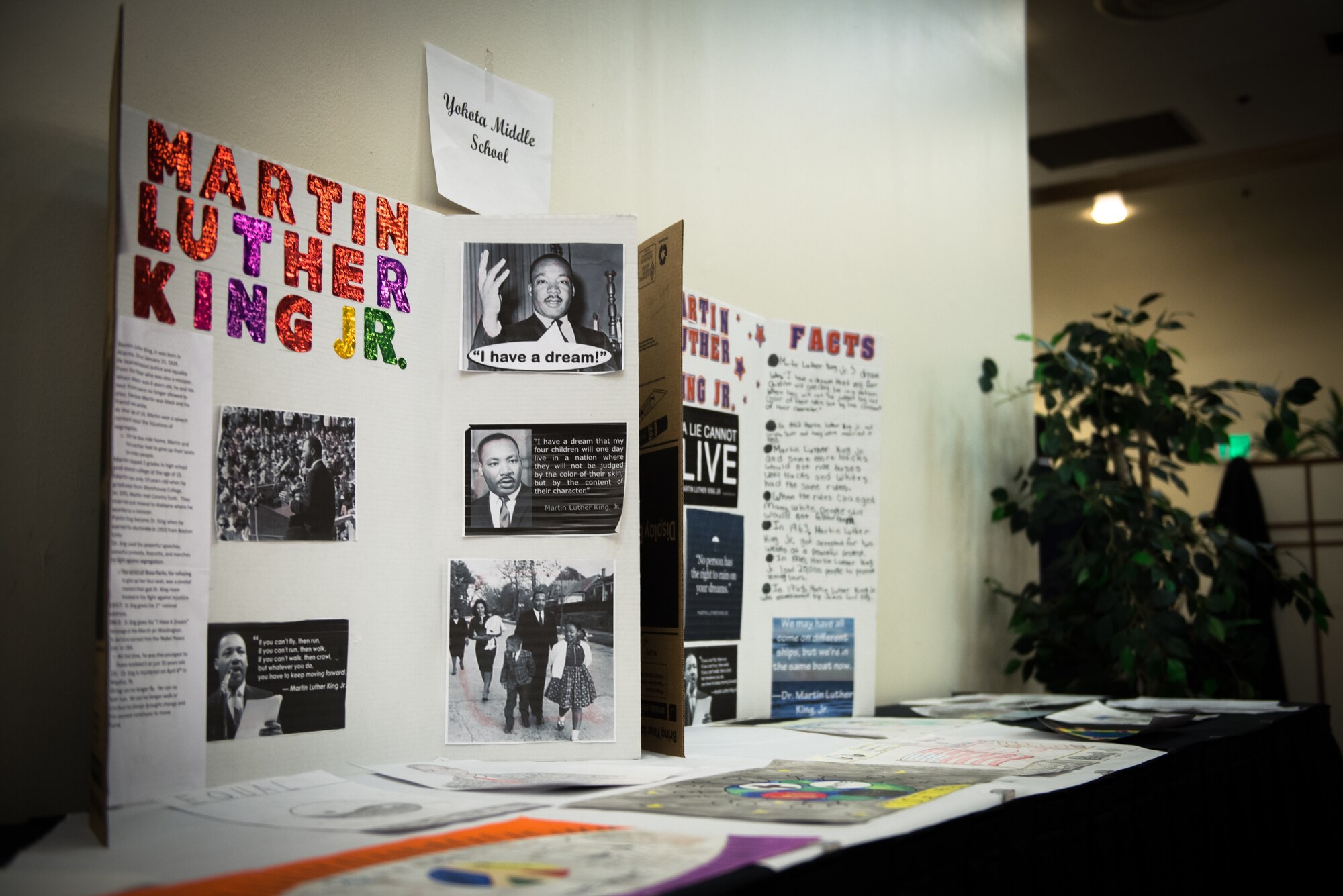 Research projects on Dr. Mather Luther King Jr. from Yokota Middle School sit displayed on a table at the MLK Jr. Luncheon at Yokota Air Base, Japan, Jan. 14, 2015. The annual event is held in honor of Dr. Martin Luther King Jr. and his accomplishments. (U.S. Air Force photo by Staff Sgt. Michael Smith/Released)