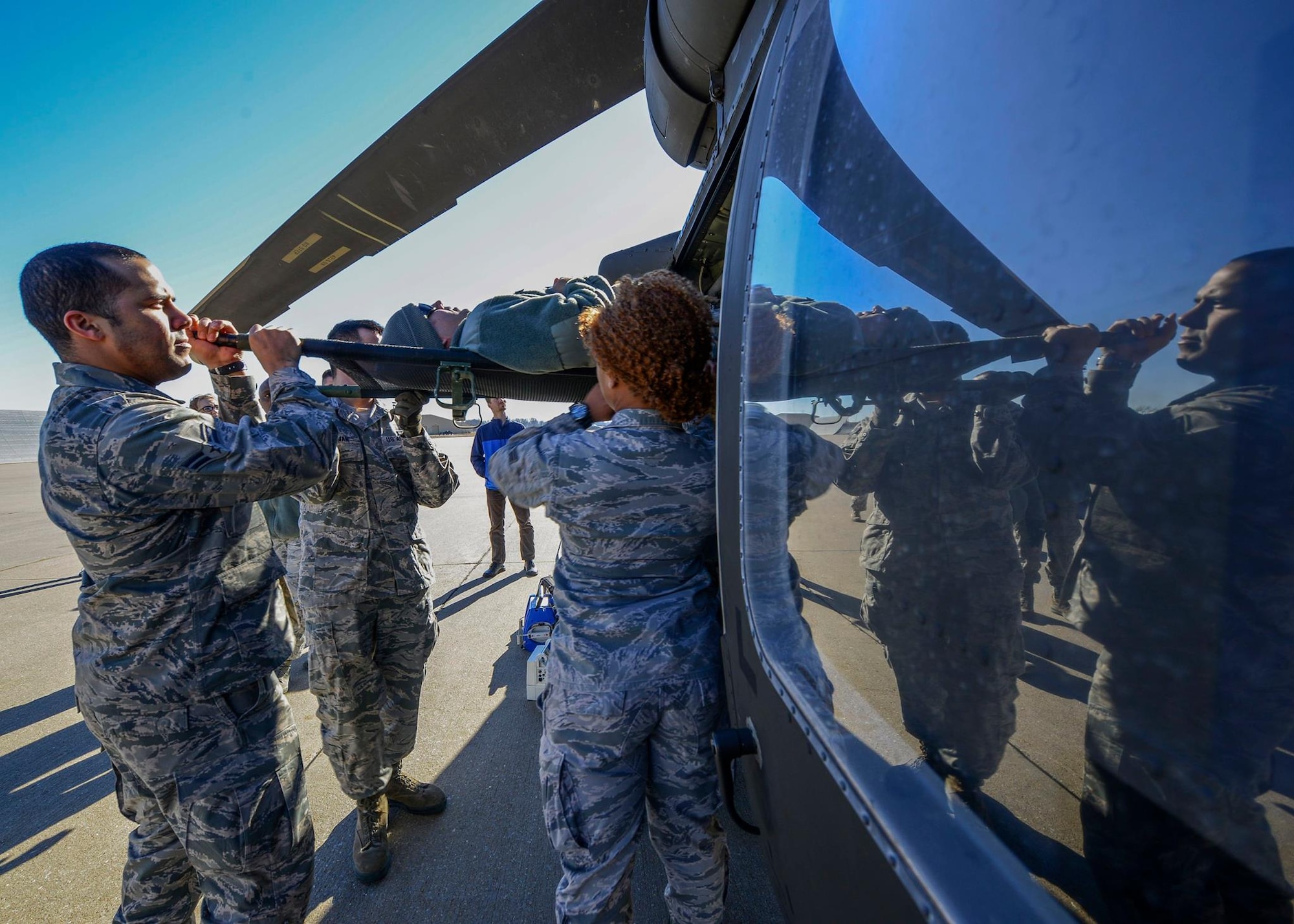 Airmen from the 22nd Medical Group lift an Airman into a HH-60M Black Hawk during medical evacuation training, Jan. 14, 2016, at McConnell Air Force Base, Kan. The training helped Airmen learn the layout of the aircraft and how to enter the aircraft safely while getting an injured person to safety. (U.S. Air Force photo/Airman 1st Class Christopher Thornbury)