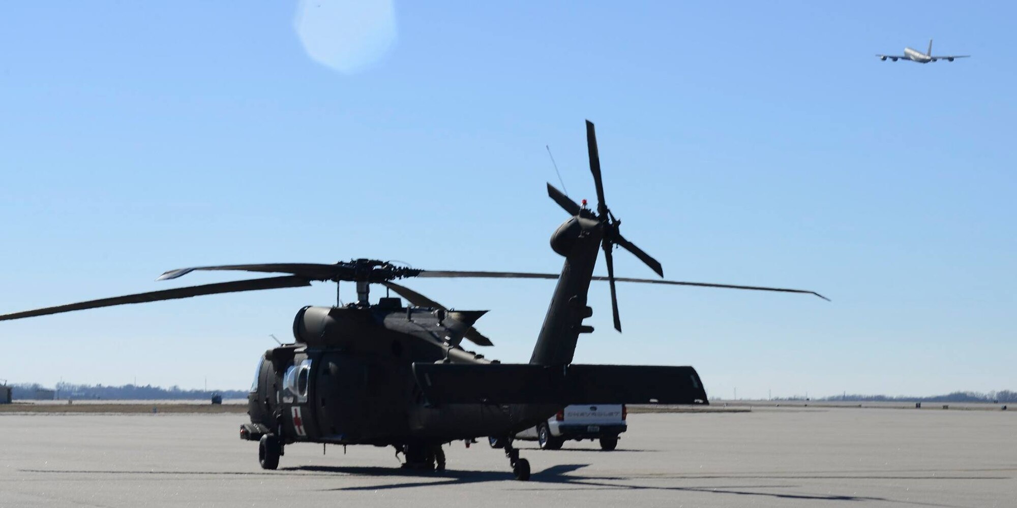 A KC-135 Stratotanker takes off in front of a HH-60M Black Hawk, Jan. 14, 2016, at McConnell Air Force Base, Kan. Soldiers from the 1st Combat Aviation Brigade, 1st Infantry Division, Fort Riley, Kan., worked with Airmen from the 22nd Medical Group during medical evacuation training. (U.S. Air Force photo/Airman 1st Class Christopher Thornbury)