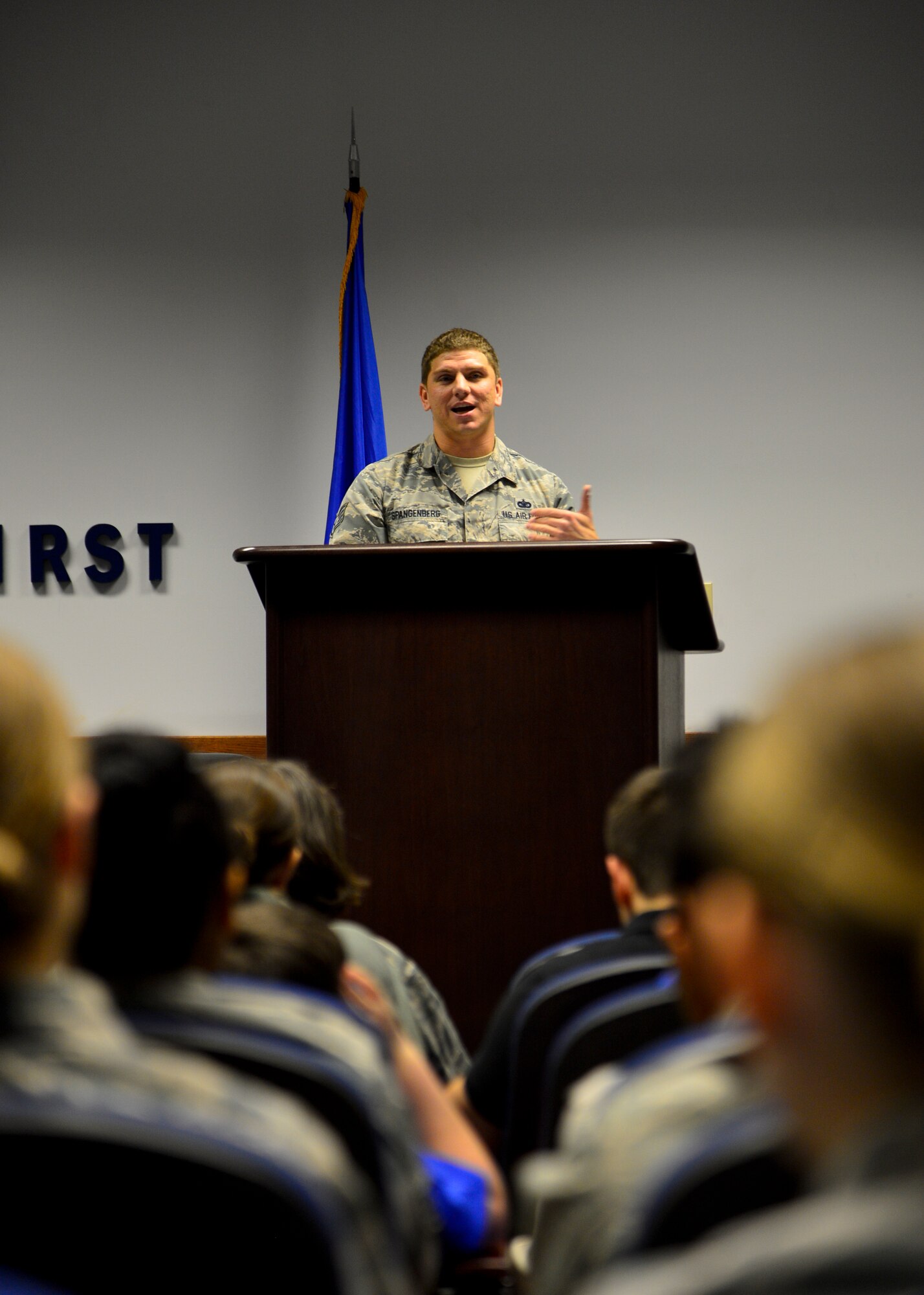 Staff Sgt. Jason Spangenberg, 436th Security Forces Squadron military working dog trainer speaks at MWD Rico/M137’s retirement ceremony Jan. 15, 2016, at Dover Air Force Base, Del. Spangenberg has been Rico’s handler for three years and is adopting him upon his retirement. (U.S. Air Force photo/Senior Airman William Johnson)
