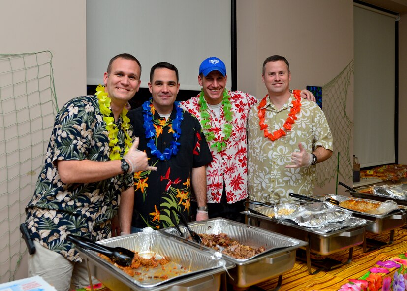 From left to right, Lt. Col. Aaron Oelrich, 436th Operations Support Squadron commander, Lt. Col. Charles Throckmorton, 436th OSS director of operations, Lt. Col. Matthew Husemann, 9th Airlift Squadron commander, and Lt. Col. Jason Mills, 3d AS commander, pose for a photo during a Deployed Families and Spouses Dinner Jan. 14, 2016, at the Youth Center on Dover Air Force Base, Del. These dinners are hosted quarterly and this dinner was supported by the Airman and Family Readiness Center and the 436th Operations Group. (U.S. Air Force photo/Senior Airman William Johnson)
