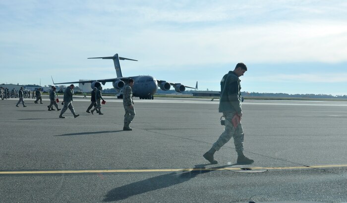 Airmen with the 437th Airlift Wing perform a weekly foreign object debris (FOD) search of the flight line at Joint Base Charleston - Air Base, S.C., Jan 14, 2016. Regular FOD walks on the taxiways and apron help prevent potential damage to the aircraft engines. (U.S. Air Force photo/Tech. Sgt Paul Polaski)
