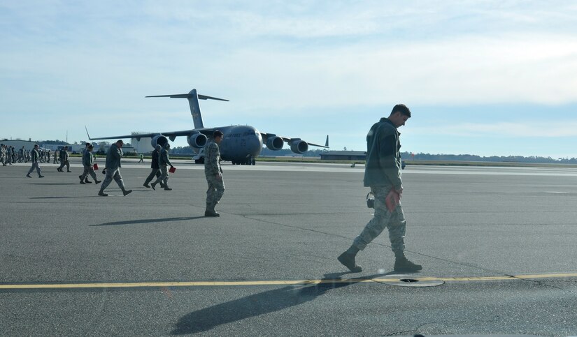 Airmen with the 437th Airlift Wing perform a weekly foreign object debris (FOD) search of the flight line at Joint Base Charleston - Air Base, S.C., Jan 14, 2016. Regular FOD walks on the taxiways and apron help prevent potential damage to the aircraft engines. (U.S. Air Force photo/Tech. Sgt Paul Polaski)
