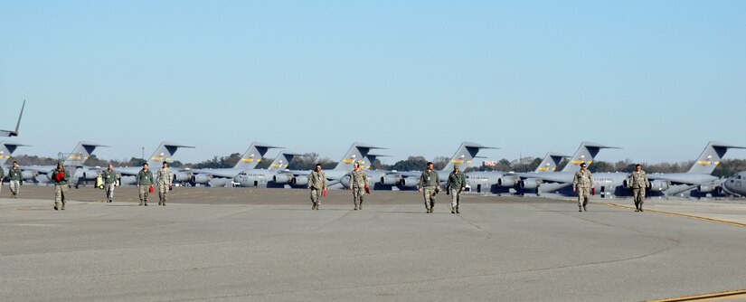 Airmen with the 437th Airlift Wing perform a weekly foreign object debris (FOD) search of the flight line at Joint Base Charleston - Air Base, S.C., Jan 14, 2016. Regular FOD walks on the taxiways and apron help prevent potential damage to the aircraft engines. (U.S. Air Force photo/Tech. Sgt Paul Polaski)
