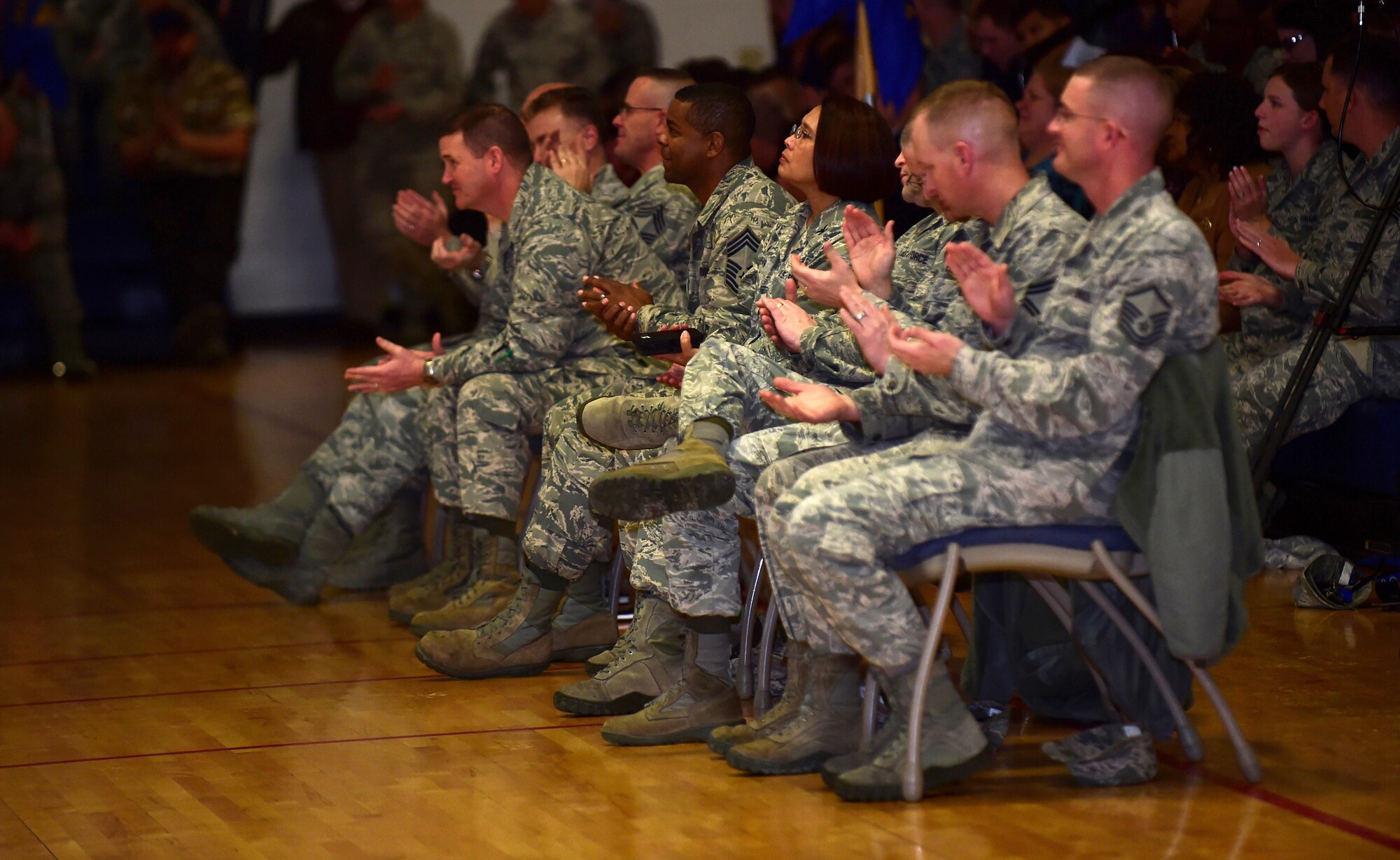 460th Space Wing leadership applauds as Col. John Wagner, 460th SW commander, speaks during a commander’s call Jan. 4, 2016, at the Buckley Fitness Center on Buckley Air Force Base, Colo. Commander’s calls are an easy way for important information to be spread to the people on Buckley AFB. (Photo by Airman 1st Class Gabrielle Spradling/Released)