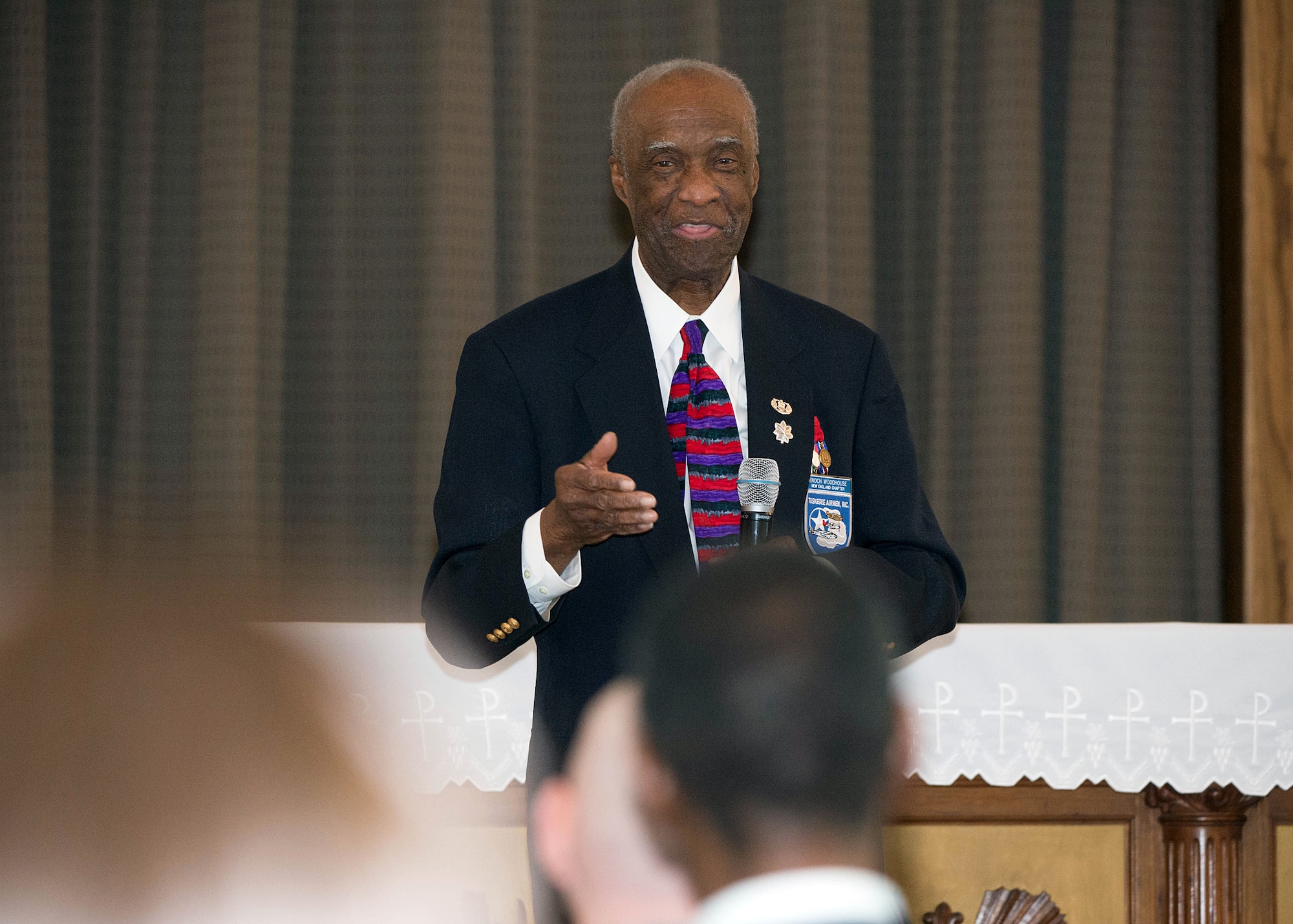Retired Lt. Col. Enoch Woodhouse III, the Dr. Martin Luther King, Jr. keynote speaker, speaks during a remembrance celebration at the base chapel Jan. 15. The event included an I Have a Dream reenactment by Timothy Martin, 66th Security Forces Squadron employee, and special music performance by Dr. Juliette Brown. (U.S. Air Force photo by Jerry Saslav)