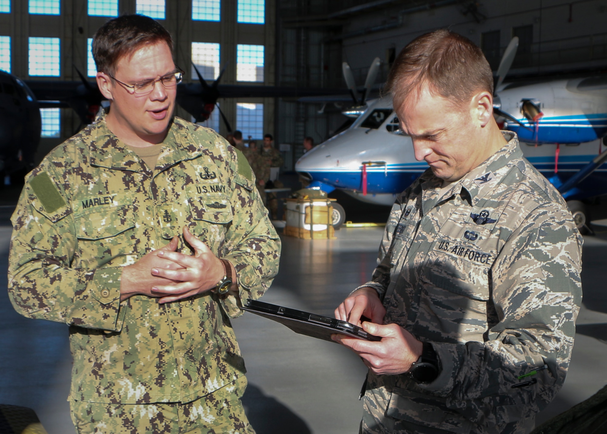 Explosive Ordnance Disposal Senior Chief Petty Officer Bert Marley, Navy Explosive Ordnance Disposal School, talks to a Commander-In-Chief’s Installation Excellence Award evaluator about the latest technology available to EOD technicians Jan. 15 at Eglin Air Force Base, Fla. Aircraft and displays from nearly every Team Eglin unit were represented in the hangar to provide a lasting impression of the base before the evaluators left to make their selections of this year’s winner.  (U.S. Air Force photo/Irene Freiberg)