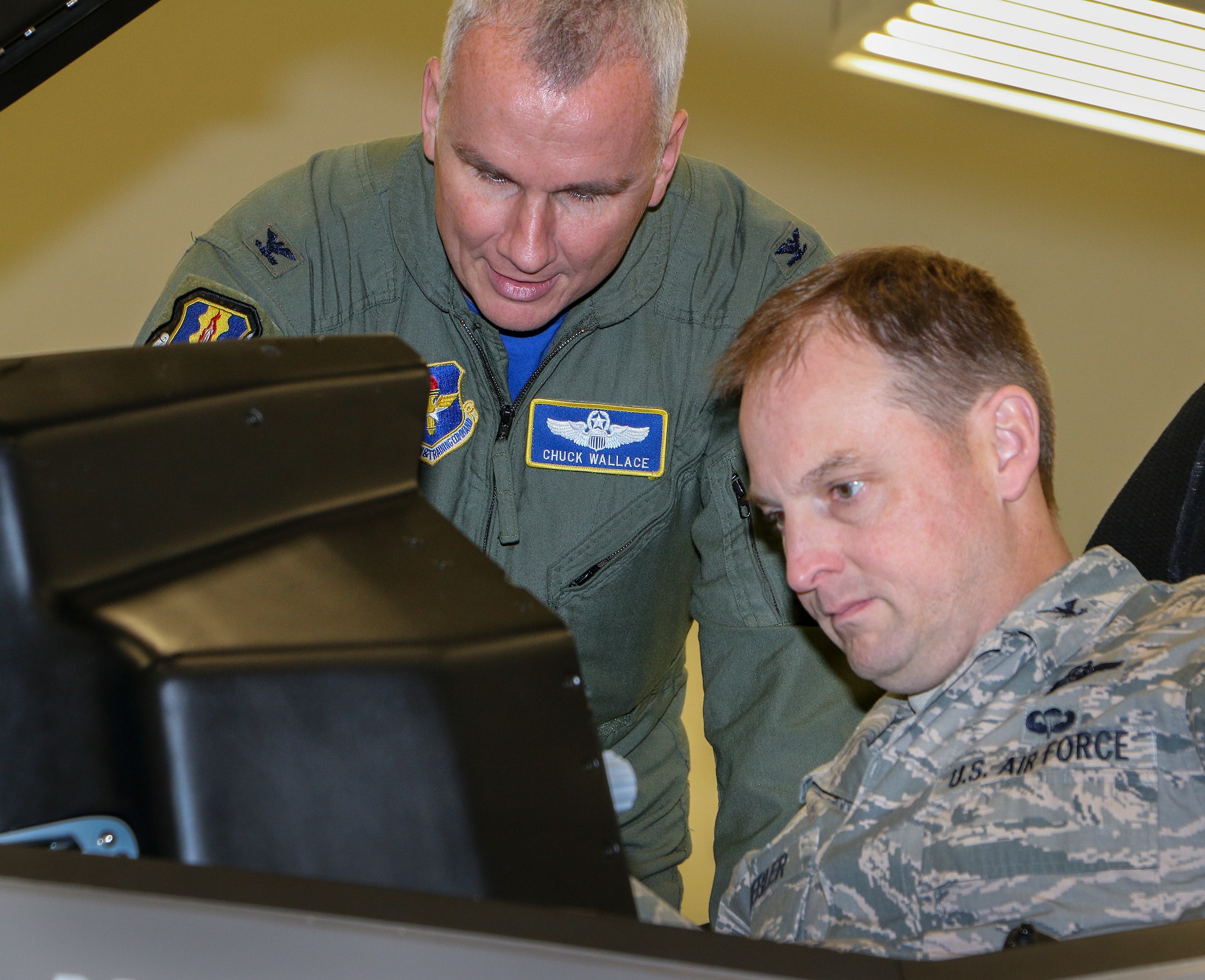 Col. Charles Wallace, 33rd Fighter Wing, briefs a Commander-In-Chief’s Installation Excellence Award evaluator on an F-35 maintenance trainer during a tour of the aircraft’s academic training center Jan. 15 at Eglin Air Force Base, Fla.  The evaluation team visited many of the base’s support units and areas on the second and final day of their tour.  (U.S. Air Force photo/Irene Freiberg)
