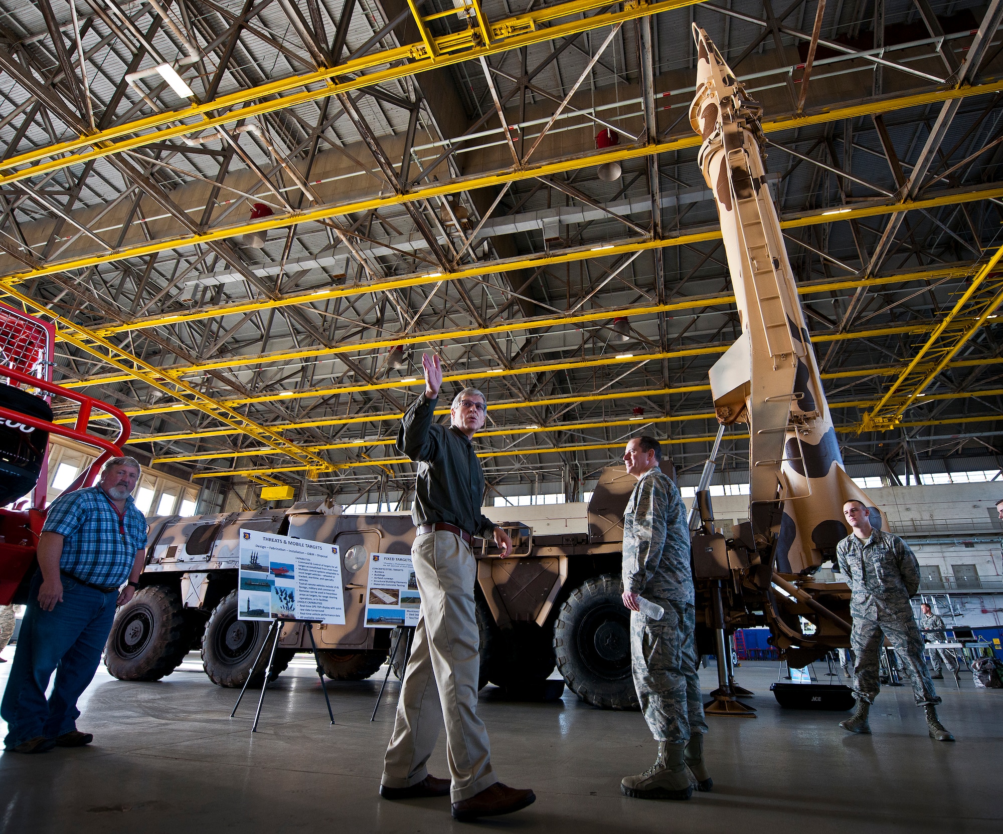One of the many base team members speaks to a Commander-In-Chief’s Installation Excellence Award evaluator about fixed and mobile targets during the team’s final stop at King Hangar Jan. 15 at Eglin Air Force Base, Fla.  Aircraft and displays from nearly every Team Eglin unit were represented in the hangar to provide a lasting impression of the base before the evaluators left to make their selections of this year’s winner.  (U.S. Air Force photo/Samuel King Jr.)