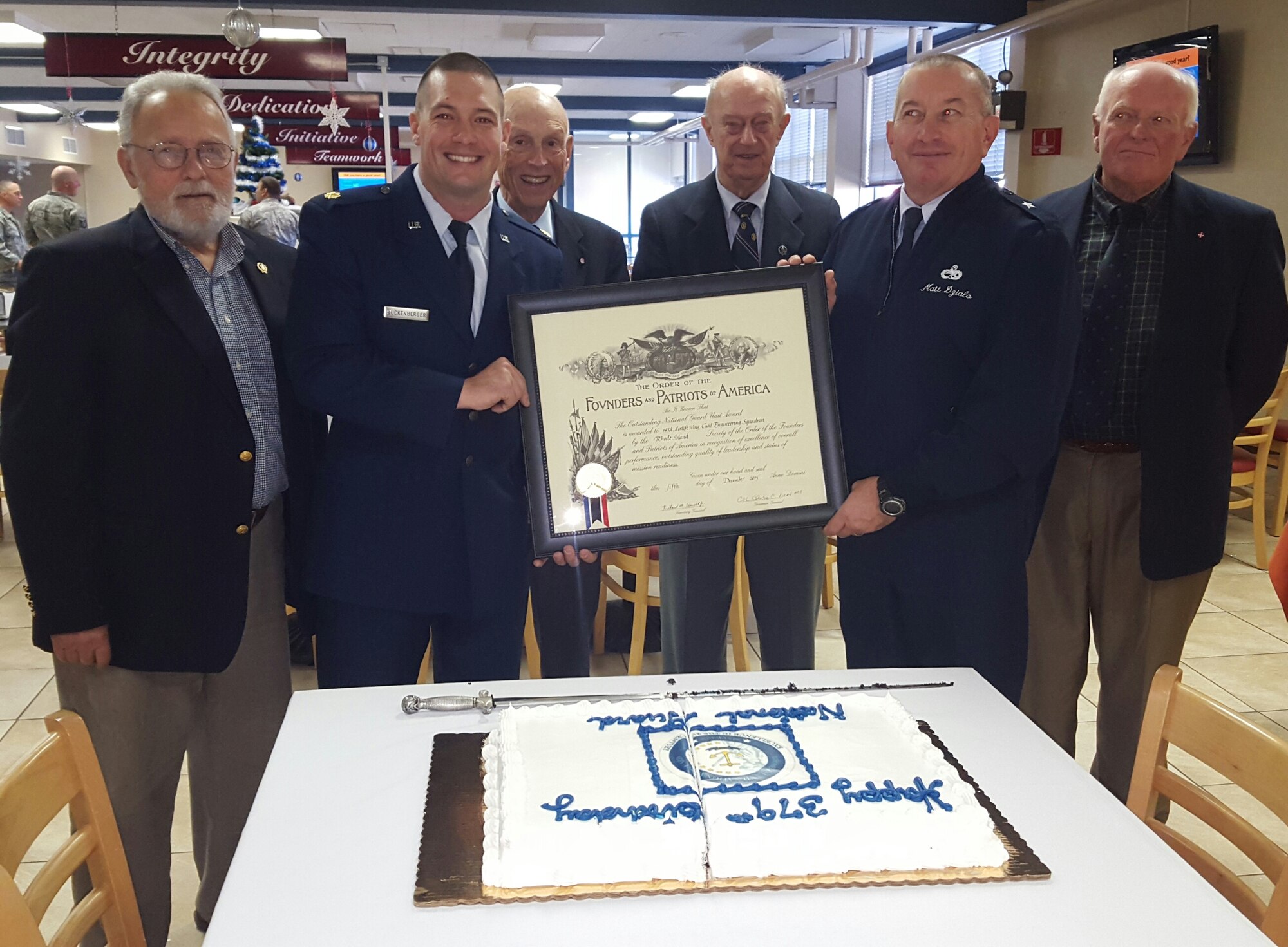 Major Jeremiah Buckenberger, 143d Civil Engineering Squadron Commander and Brigadier General Matthew Dzialo with members of the Rhode Island Society of the Founders and Patriots hold the 2015 Founders and Patriots award which was presented to the 143 CES during a ceremony at Quonset Air National Guard Base, North Kingstown, Rhode Island on December 5, 2015. Photo by Master Sgt Janeen Miller