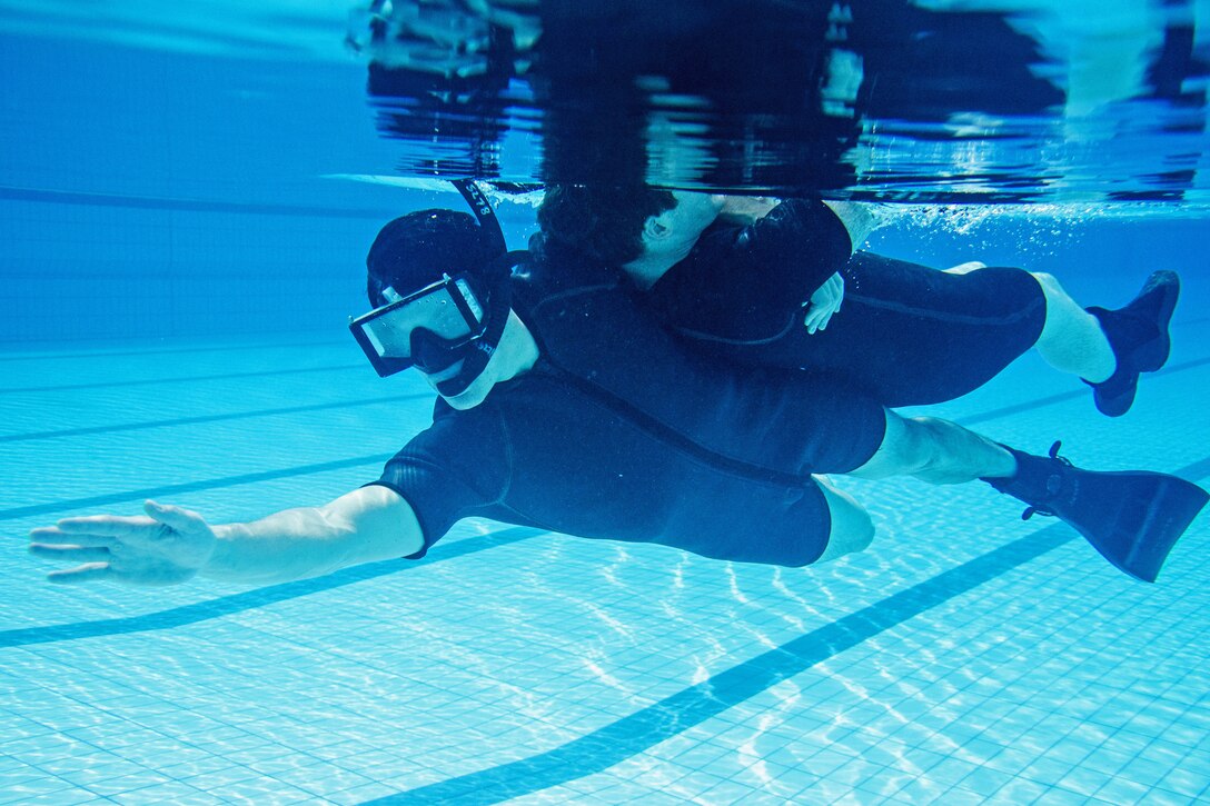 U.S. Navy Petty Officer 2nd Class Jordan Kowalski practices a buddy tow rescue maneuver in Changi, Singapore, Jan. 15, 2016. Kowalski is a rescue swimmer with Helicopter Maritime Strike Squadron 35 attached to the USS Fort Worth. The Fort Worth is on a rotational deployment to support the Asia-Pacific Rebalance. U.S. Navy photo Petty Officer 2nd Class Antonio Turretto Ramos