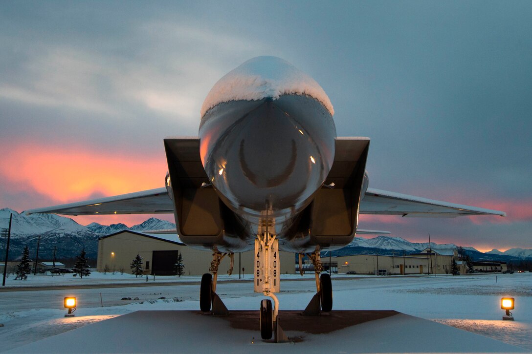 The sun rises over the Chugach Mountains with a view of the Heritage Park as the light reflects off an aircraft on Joint Base Elmendorf-Richardson, Alaska, Jan. 19, 2016. During January, Alaska has been steadily gaining an average of six hours of daylight. Air Force photo by Staff Sgt. Sheila deVera