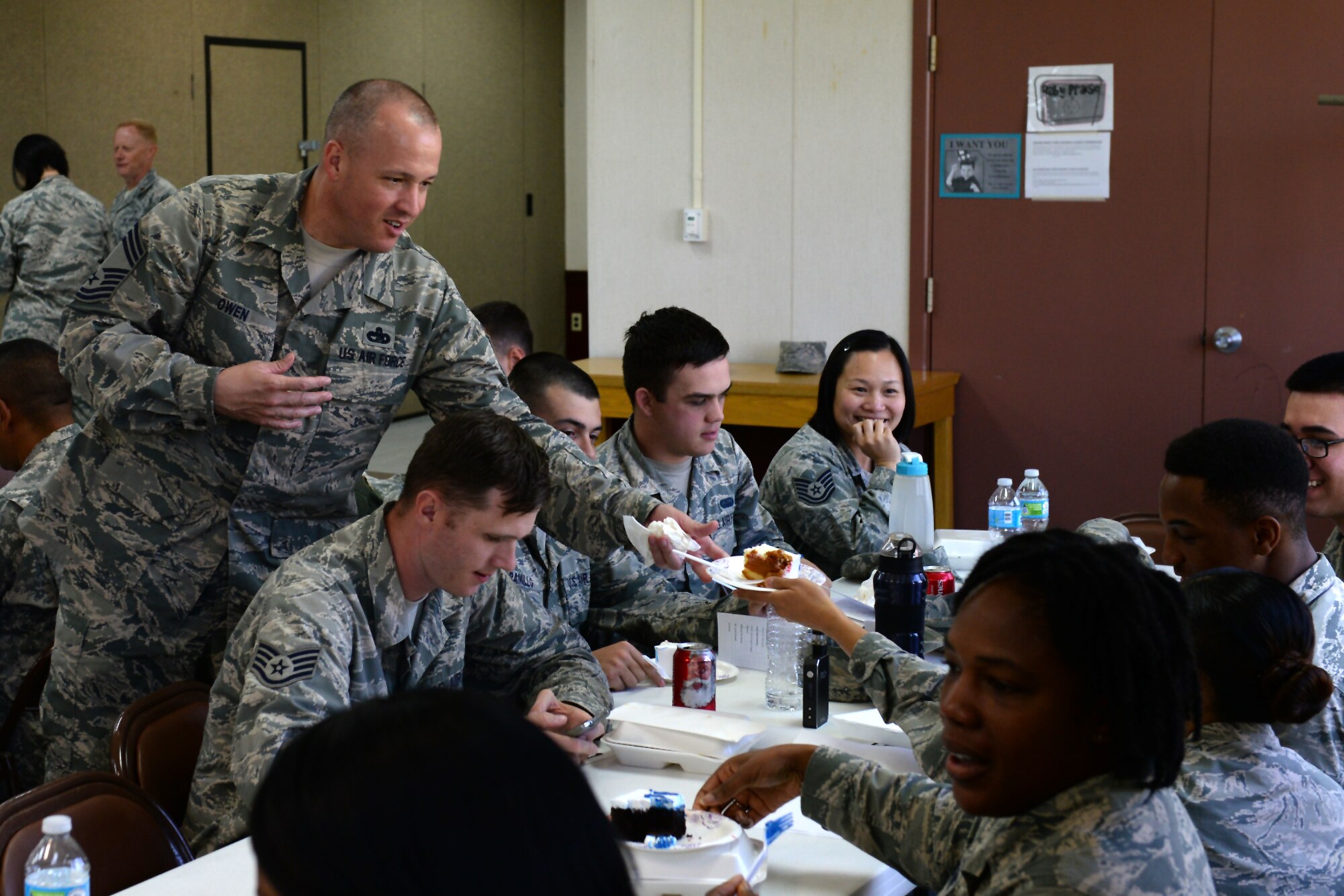 Chief Master Sgt. Travis Owen, 734th Air Mobility Squadron aerial port superintendent, serves an Airman a piece of cake during the Martin Luther King Jr. Remembrance luncheon Jan. 14, 2016, at Andersen Air Force Base, Guam. The event featured several guest speakers to include students from Andersen Schools who read their essays related to Martin Luther King Jr. and his impact. (U.S. Air Force photo/Airman 1st Class Jacob Skovo)

