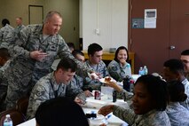 Chief Master Sgt. Travis Owen, 734th Air Mobility Squadron aerial port superintendent, serves an Airman a piece of cake during the Martin Luther King Jr. Remembrance luncheon Jan. 14, 2016, at Andersen Air Force Base, Guam. The event featured several guest speakers to include students from Andersen Schools who read their essays related to Martin Luther King Jr. and his impact. (U.S. Air Force photo/Airman 1st Class Jacob Skovo)

