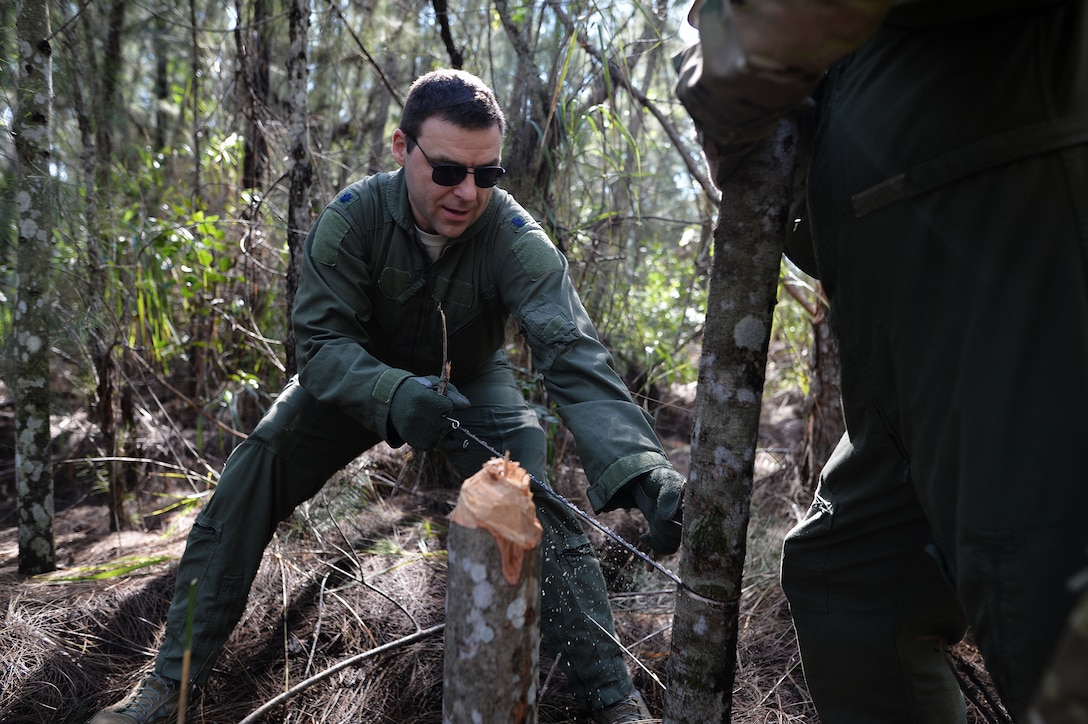 Air Force Lt. Col. Scott Stenger practices using a handheld saw during combat and water survival training on Homestead Air Reserve Base, Fla., Jan. 18, 2016. Stenger is assigned to the 106th Rescue Wing. New York Air National Guard photo by Staff Sgt. Christopher S. Muncy