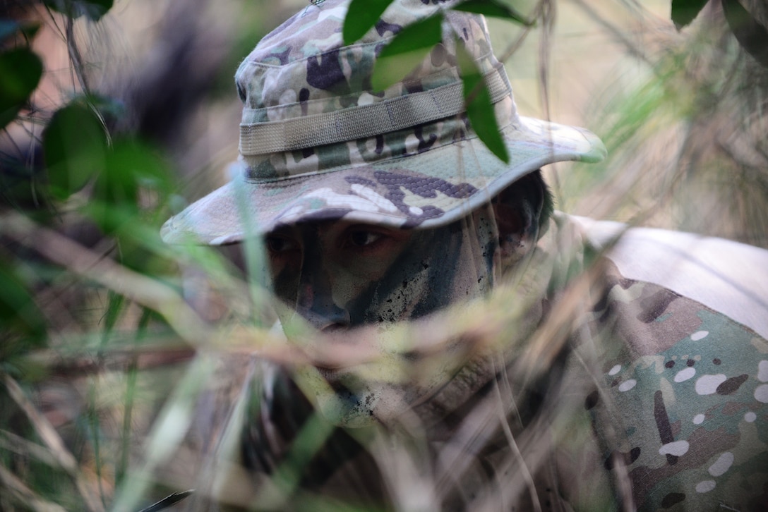 Air Force Staff Sgt. Brian Alfano tries to blend in with the environment during combat and water survival training course on Homestead Air Reserve Base, Fla., Jan. 18, 2016. Alfano is a survival, evasion, resistance, and escape instructor assigned to the 103rd Rescue Squadron. New York Air National Guard photo by Staff Sgt. Christopher S. Muncy