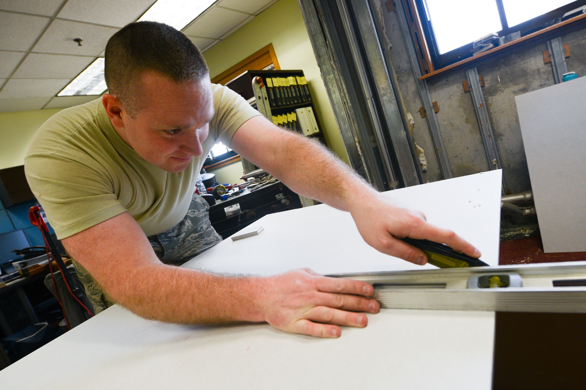 Firefighters from the 51st Civil Engineer Squadron construct a drywall room during construction at Osan Air Base, Republic of Korea, Jan. 14, 2015. The firefighters renovated one of the fire station’s rooms to provide better inspection production and customer service from their fire-prevention team. (U.S. Air Force photo by Airman 1st Class Dillian Bamman/Released)