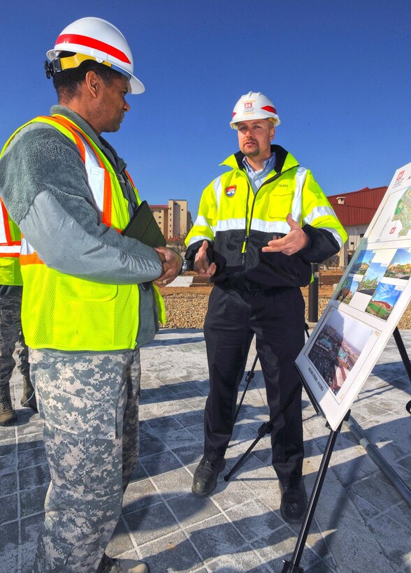 In this photo, Chaplain (Col.) Raymond A. Robinson, Jr., the USFK command chaplain, pauses in front of the nearly completed chapel #1 to receive a briefing from David M. Talbot, resident engineer of the Far East District's Family Housing Resident Office at Camp Humphreys.

One critical aspect of any military installation is a space that allows for service members to exercise their freedom of religion. For a military city, greater numbers and diversity demand more than just a single space. The first of four new chapels is slated to be put into use by mid-2016.

Until around 2014, U.S. Army Garrison-Humphreys personnel exercised their freedom of religion using one small chapel (the Freedom Chapel) and a small worship space in the 501st Military Intelligence area, said Robinson. Since the Freedom Chapel was demolished, the chaplains have been holding services in the Humphreys high school through a facility usage agreement with the Department of Defense Education Activity. 
“Many of us in the Far East District have been personally invested in the construction of these chapels, and we’re going to be just as excited as the rest of the Chapel community to see this and our other new chapels open up,” said Talbot.
