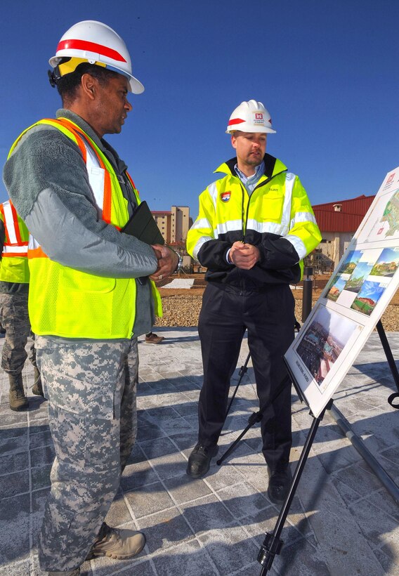 In this photo, Chaplain (Col.) Raymond A. Robinson, Jr., the USFK command chaplain, gets briefed on the nearly completed chapel #1 by David M. Talbot, resident engineer of the Far East District's Family Housing Resident Office at Camp Humphreys.

One critical aspect of any military installation is a space that allows for service members to exercise their freedom of religion. For a military city, greater numbers and diversity demand more than just a single space. The first of four new chapels is slated to be put into use by mid-2016.

Until around 2014, U.S. Army Garrison-Humphreys personnel exercised their freedom of religion using one small chapel (the Freedom Chapel) and a small worship space in the 501st Military Intelligence area, said Robinson. Since the Freedom Chapel was demolished, the chaplains have been holding services in the Humphreys high school through a facility usage agreement with the Department of Defense Education Activity. 

“Many of us in the Far East District have been personally invested in the construction of these chapels, and we’re going to be just as excited as the rest of the Chapel community to see this and our other new chapels open up,” said Talbot.
