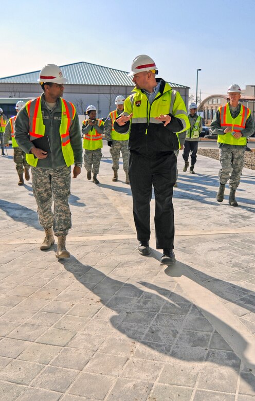 In this photo, Chaplain (Col.) Raymond A. Robinson, Jr., the USFK command chaplain (front left), tours the nearly completed chapel #1 with David M. Talbot, resident engineer of the Far East District's Family Housing Resident Office at Camp Humphreys (front right).

One critical aspect of any military installation is a space that allows for service members to exercise their freedom of religion. For a military city, greater numbers and diversity demand more than just a single space. The first of four new chapels is slated to be put into use by mid-2016.

Until around 2014, U.S. Army Garrison-Humphreys personnel exercised their freedom of religion using one small chapel (the Freedom Chapel) and a small worship space in the 501st Military Intelligence area, said Robinson. Since the Freedom Chapel was demolished, the chaplains have been holding services in the Humphreys high school through a facility usage agreement with the Department of Defense Education Activity. 

“Many of us in the Far East District have been personally invested in the construction of these chapels, and we’re going to be just as excited as the rest of the Chapel community to see this and our other new chapels open up,” said Talbot.
