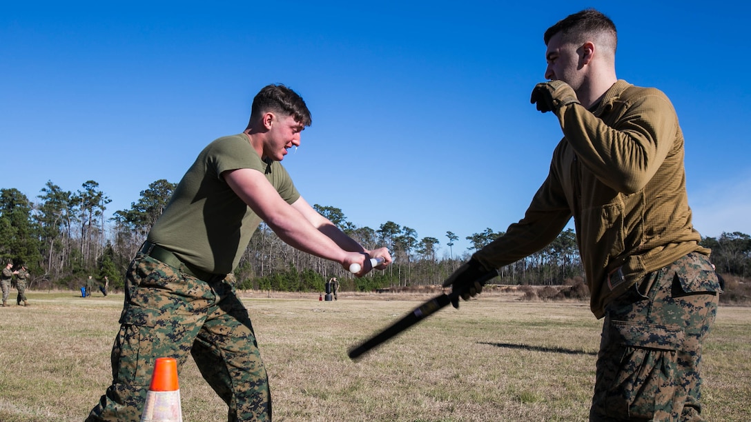 Lance Cpl. Hunter Rooks, a Marine with Combat Logistics Battalion 22, deflects baton attacks from an assailant after being sprayed with oleoresin capsicum, more commonly known as OC spray, at Camp Lejeune, N.C., Jan. 14. “The purpose of this course is to gain compliance without using lethal force,” said Cpl. Hayden Jolly, an artillery section chief with the unit. 