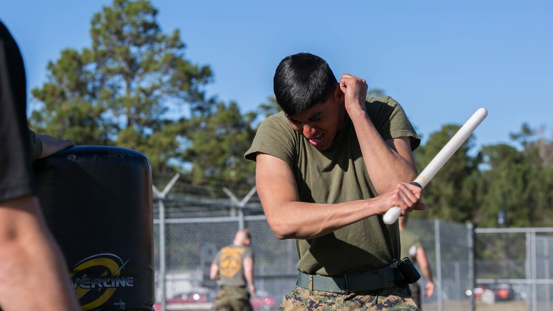 A Marine with Combat Logistics Battalion 22 attacks a stationary punching bag with a baton after being sprayed in the eyes with oleoresin capsicum, more commonly known as OC spray, at Camp Lejeune, N.C., Jan. 14. CLB-22 Marines have been enrolled in the course for a week and have started studying the effects and purposes of OC spray. Marines often use OC spray when mechanical control holds or other takedown techniques are no longer safe to execute. 