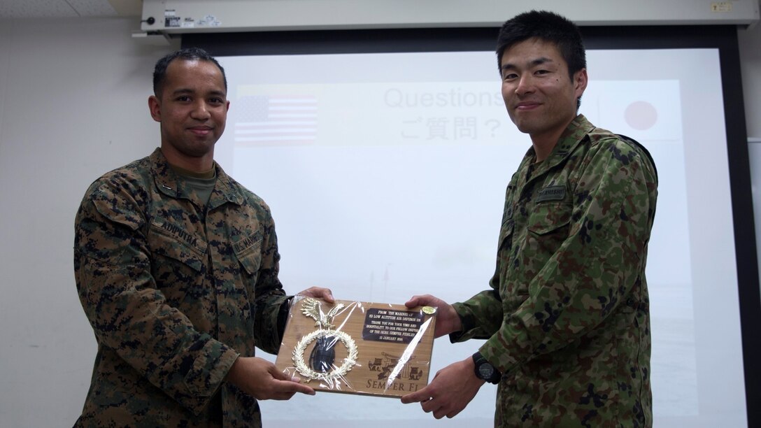Marine 1st Lt. Yosef E. Adiputra presents a gift to Japan Ground Self-Defense Force 1st Lt. Takahashi during a tour of JGSDF facilities Jan. 13 at Camp Komakado, Shizuoka, Japan. The visit strengthened the relationship between Marines and JGSDF members by allowing the service members to observe each other’s training methods and operations. The Marines from 2nd Low Altitude Air Defense Battalion, Marine Aircraft Control Group 28; currently assigned to the 31st Marine Expeditionary Unit, III Marine Expeditionary Force under the unit deployment program, visited their JGSDF counterpart, 1st Anti-Aircraft Battalion, observed weapon systems, tactical vehicles and martial arts demonstrations.