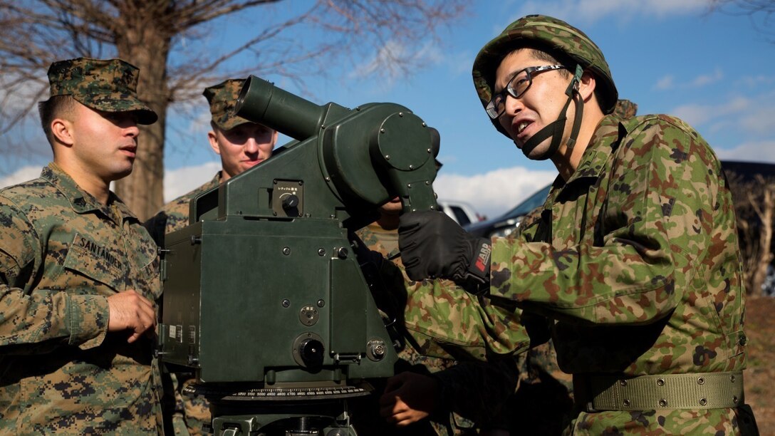 A member of the Japan Ground Self-Defense Force demonstrates the use of a targeting optical aide during a tour of Japan Ground Self-Defense Force facilities Jan. 13 at Camp Komakado, Shizuoka, Japan. The visit strengthened the relationship between Marines and their JGSDF counterpart, 1st Anti-Aircraft Battalion, by allowing them to observe training procedures, weapon systems, tactical vehicles and equipment. The Marines are from 2nd Low Altitude Air Defense Battalion, Marine Aircraft Control Group 28; currently assigned to the 31st Marine Expeditionary Unit, III Marine Expeditionary Force under the unit deployment program.