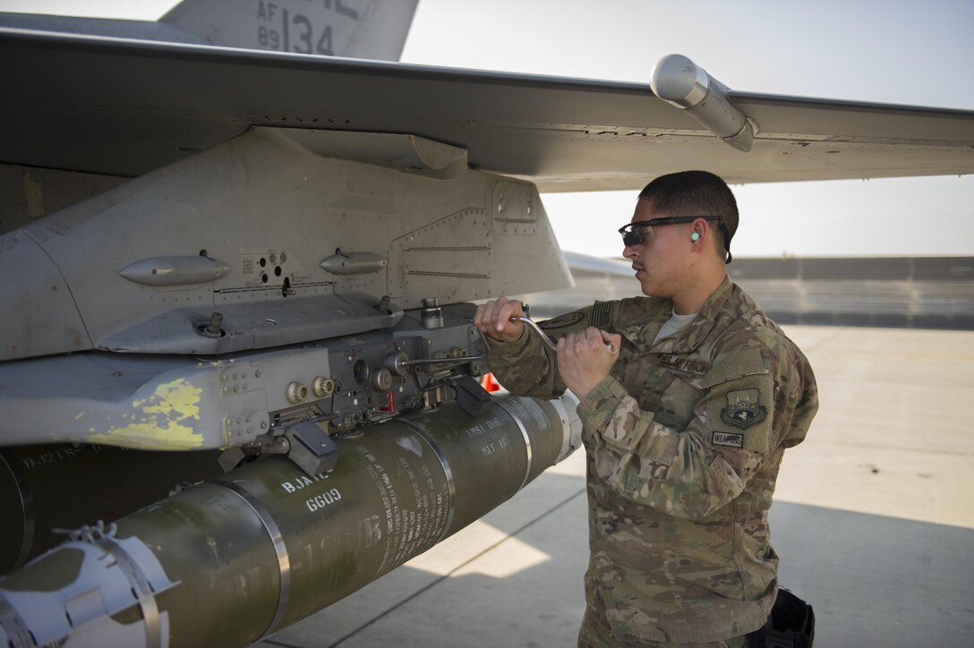 Air Force Airman 1st Class Gabriel Rey removes an impulse cartridge retainer from an F-16 Fighting Falcon aircraft during a 30-day inspection on Bagram Airfield, Afghanistan, Jan. 15, 2016. Rey is a weapons load crew member assigned to the 455th Expeditionary Aircraft Maintenance Squadron. The weapons team performs a critical role for the close air support missions, ensuring pilots have the correct and functional munitions. U.S. Air Force photo by Tech. Sgt. Robert Cloys