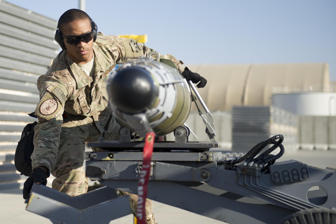 Air Force Staff Sgt. Chris White moves a GBU-54 to a bomb stand during a 30-day inspection on Bagram Airfield, Afghanistan, Jan. 15, 2016. U.S. Air Force photo by Tech. Sgt. Robert Cloys