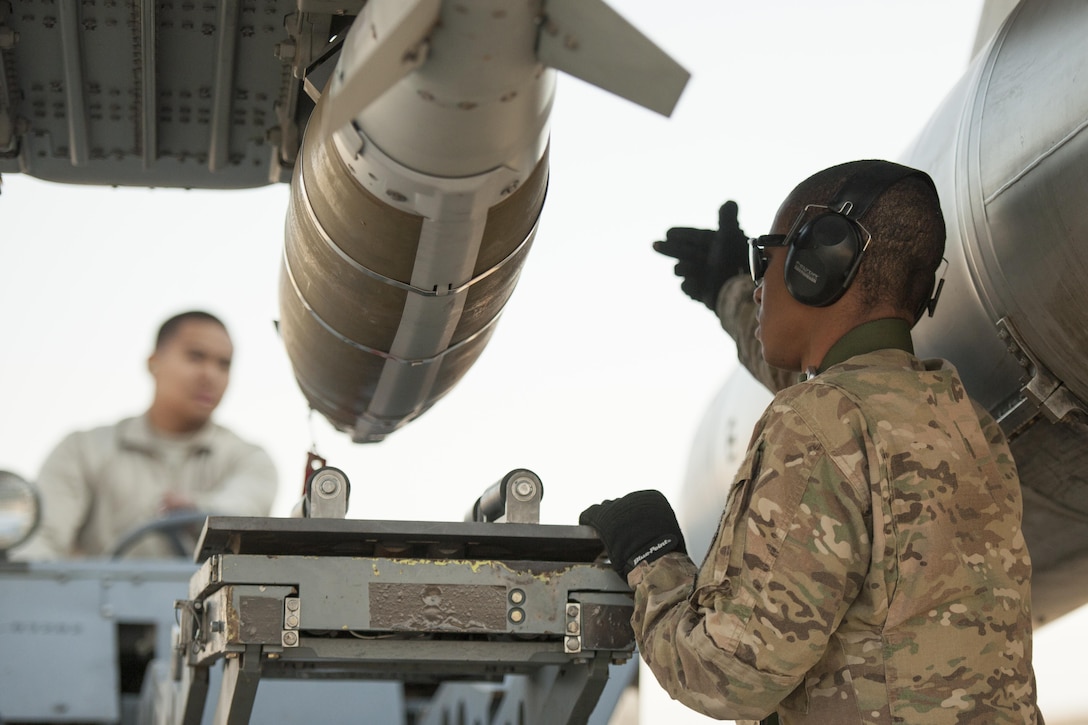 Air Force Staff Sgt. Chris White, right, and Air Force Airman 1st Class Rhaymark Neri download a GBU-54 from an F-16 Fighting Falcon aircraft to complete a 30-day inspection on Bagram Airfield, Afghanistan, Jan. 15, 2016. U.S. Air Force photo by Tech. Sgt. Robert Cloys