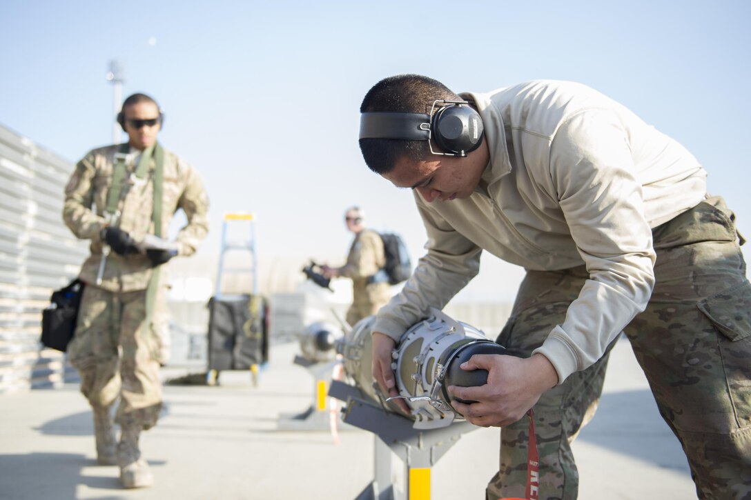 Air Force Airman 1st Class Rhaymark Neri secures a sensor cover on a GBU-54 on Bagram Airfield, Afghanistan, Jan. 15, 2016. Neri is a weapons load crew member assigned to the 455th Expeditionary Aircraft Maintenance Squadron. U.S. Air Force photo by Tech. Sgt. Robert Cloys