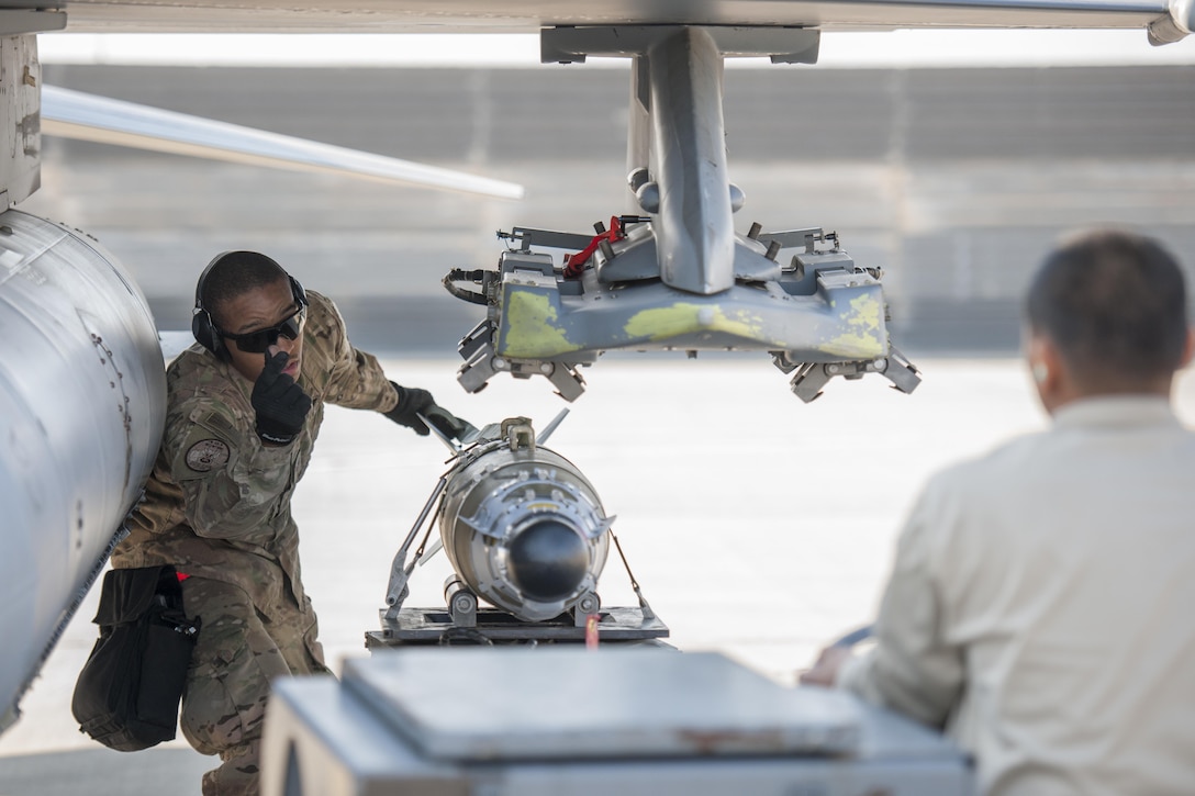 Air Force Staff Sgt. Chris White, left, and Airman 1st Class Rhaymark Neri load a GBU-54 to an F-16 Fighting Falcon aircraft during a 30-day inspection on Bagram Airfield, Afghanistan, Jan. 15, 2016. U.S. Air Force photo by Tech. Sgt. Robert Cloys