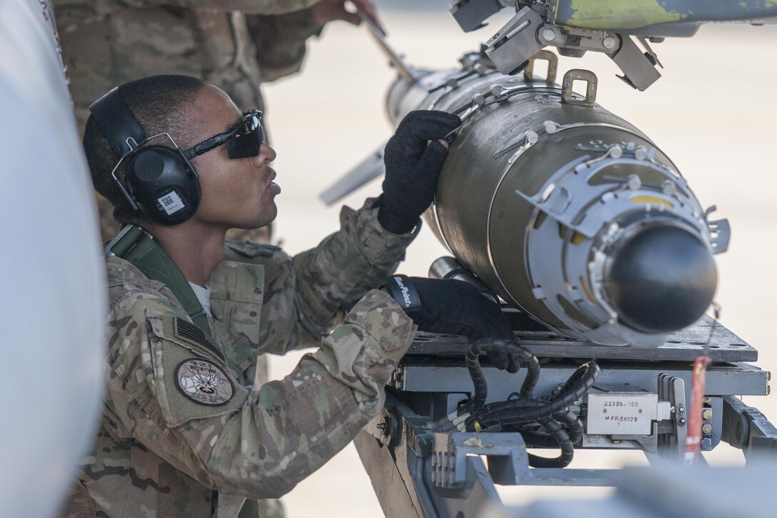 Air Force Staff Sgt. Chris White loads a GBU-54 to an F-16 Fighting Falcon aircraft during a 30-day inspection on Bagram Airfield, Afghanistan, Jan. 15, 2016. U.S. Air Force photo by Tech. Sgt. Robert Cloys