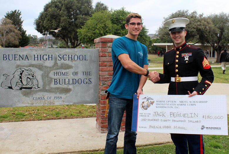 Sergeant Weldon Housley, recruiter of Recruiting Sub Station Ventura, shakes hands with Jack Beguelin, after presenting him with a Naval Reserve Officers Training Corps scholarship check at Buena High School in Ventura, Calif., Jan. 15, 2016. The NROTC scholarship, valued at up to $180,000, will pay for the cost of full tuition, books and other educational fees at many of the country’s leading colleges and universities. (U.S. Marine Corps photo by Staff Sgt. Alicia R. Leaders/Released)