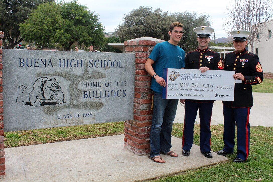 Sergeant Weldon Housley, center, and Staff Sergeant Edwin Salvatierra, right, present a Naval Reserve Officers Training Corps scholarship check to Jack Beguelin at Buena High School in Ventura, Calif., Jan. 15, 2016. The NROTC scholarship, valued at up to $180,000, will pay for the cost of full tuition, books and other educational fees at many of the country’s leading colleges and universities. (U.S. Marine Corps photo by Staff Sgt. Alicia R. Leaders/Released)