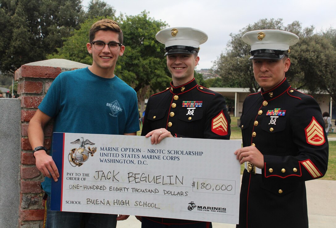 Sergeant Weldon Housley, center, and Staff Sergeant Edwin Salvatierra, right, present a Naval Reserve Officers Training Corps scholarship check to Jack Beguelin at Buena High School in Ventura, Calif., Jan. 15, 2016. The NROTC scholarship, valued at up to $180,000, will pay for the cost of full tuition, books and other educational fees at many of the country’s leading colleges and universities. (U.S. Marine Corps photo by Staff Sgt. Alicia R. Leaders/Released)