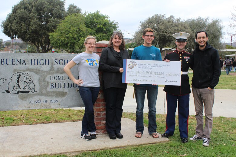 Sergeant Weldon Housley, and the staff of Buena High School present a Naval Reserve Officers Training Corps scholarship check to Jack Beguelin, Jan. 15, 2016, in Ventura, Calif. The NROTC scholarship, valued at up to $180,000, will pay for the cost of full tuition, books and other educational fees at many of the country’s leading colleges and universities. (U.S. Marine Corps photo by Staff Sgt. Alicia R. Leaders/Released)
