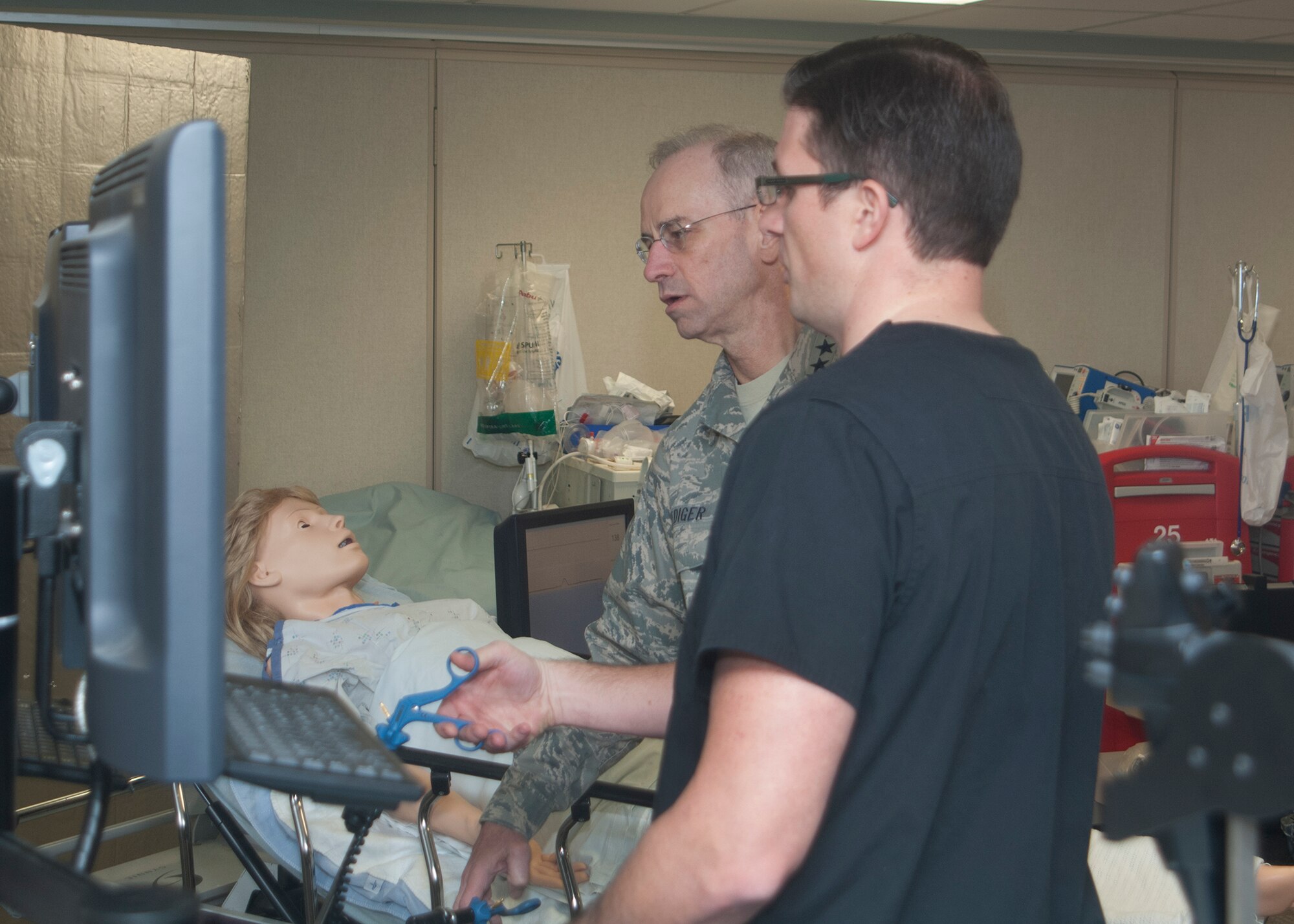 Mr. Kiley Gerritsen, Simulation Coordinator, demonstrates the laproscopic simulator to Air Force Surgeon General Lt. Gen Mark Ediger at the Wright-Patterson Medical Center's Simulation Center during his visit to Wright-Patterson AFB on Jan. 13, 2015. 