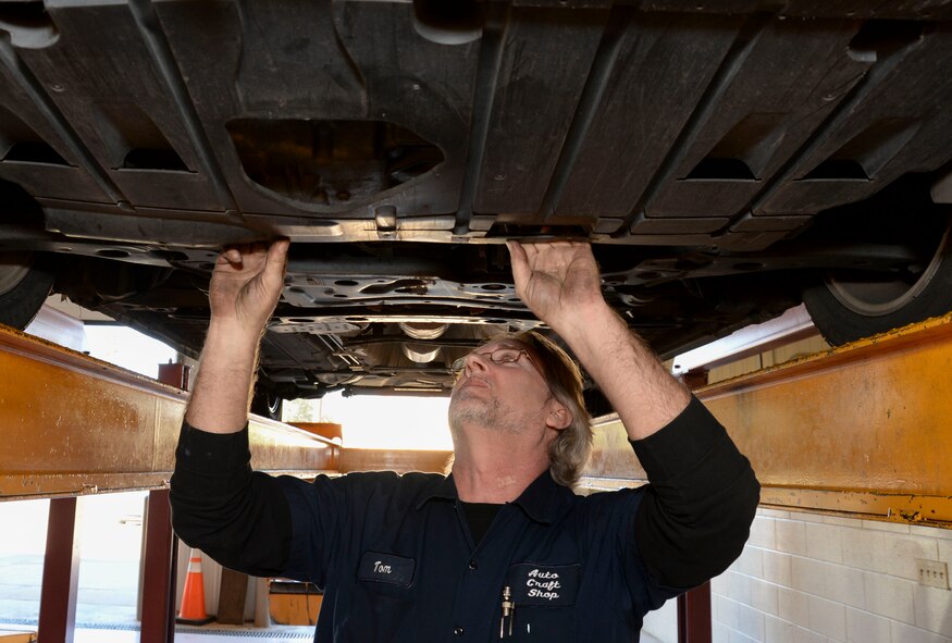Tom Hunnicutt, 2nd Force Support Squadron automotive mechanic, searches for the oil drain plug at the Auto Hobby Center, Barksdale Air Force Base, La., Jan. 13, 2016. The center is open for do-it-yourself repairs on a first-come, first-served basis. Available resources include a car wash, several vacuums, five lift stalls, three maintenance stalls, various tools and diagnostic support. (U.S. Air Force photo by Senior Airman Amanda Morris)