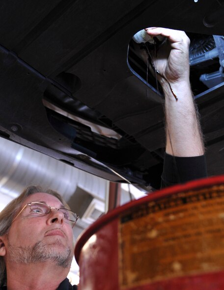 Tom Hunnicutt, 2nd Force Support Squadron automotive mechanic, removes an old oil filter at the Auto Hobby Center, Barksdale Air Force Base, La., Jan. 13, 2016. If a customer doesn’t have the knowledge or time to perform do-it-yourself repairs, the center’s mechanics can assist with minor maintenance and repairs for an hourly rate. (U.S. Air Force photo by Senior Airman Amanda Morris)