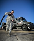 Airman 1st Class Ivan Saldivar, 2nd Logistics Readiness Squadron fuel distribution operator, carries a fuel hose from an R-12 hydrant servicing truck at Barksdale Air Force Base, La., Jan. 11, 2016. This truck fuels aircraft faster than conventional trucks by pumping fuel directly from the underground piping system. (U.S. Air Force photo/Airman 1st Class Mozer O. Da Cunha)