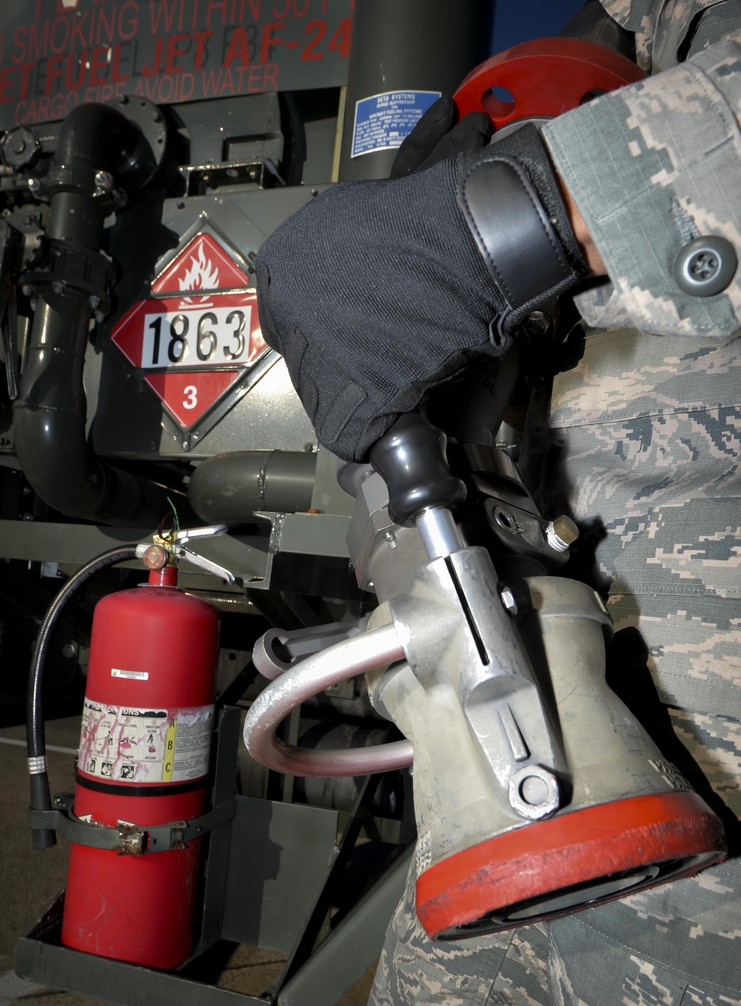 Airman 1st Class Ivan Saldivar, 2nd Logistics Readiness Squadron fuel distribution operator, holds a fuel nozzle from an R-12 hydrant servicing truck at Barksdale Air Force Base, La., Jan. 11, 2016. Fuel nozzles assist with delivering up to 600 gallons of fuel per minute to aircraft and emergency response vehicles. (U.S. Air Force photo/Airman 1st Class Mozer O. Da Cunha)